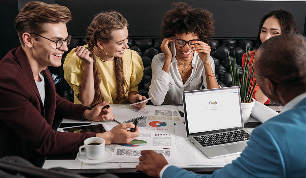 Group of people in a meeting with a computer
