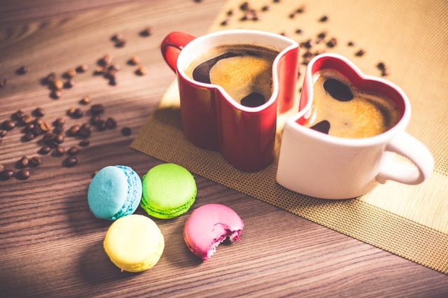 Photo of two coffee mugs and snacks